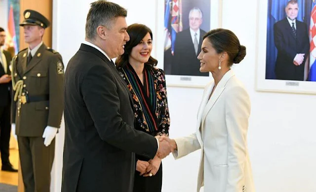 Queen Letizia wore a slim-fit tuxedo-style jacket by Hugo Boss. First Lady Sanja Music Milanovic wore a kimono floral print blouse