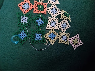 3 rows of square tatted motifs, with partial of 4th row at top. Motifs alternate square set and on-point. They are two colors, inner and outer to show low temperature and high temperature. A stitch marker on the left one shows where next motif should go