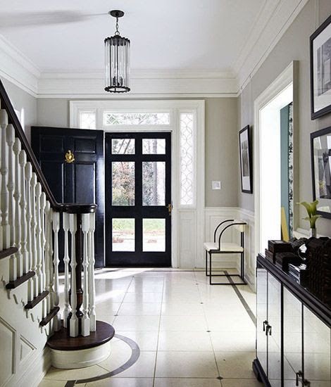 beautiful traditional  black and white marble entry foyer with black door