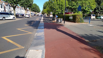 A red continuous treatment over a vehicle access.