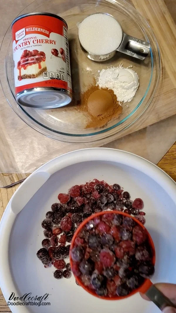 Step 1: Mix Pie Filling  Add one can of cherry pie filling into a mixing bowl.   Add 1/2 cup of sugar.   Add 2 tablespoons of cornstarch.   Add 1 tablespoon of cinnamon.   Add 2 cups of frozen Three Berry blend.