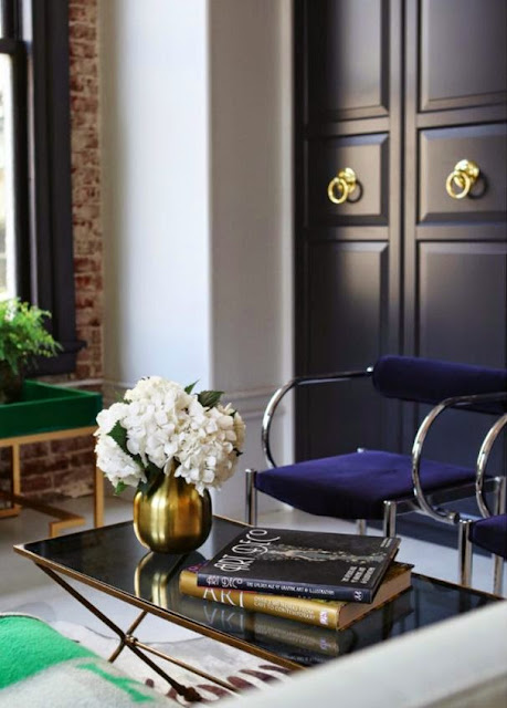 vignette black and gold table black painted doors pop of green color