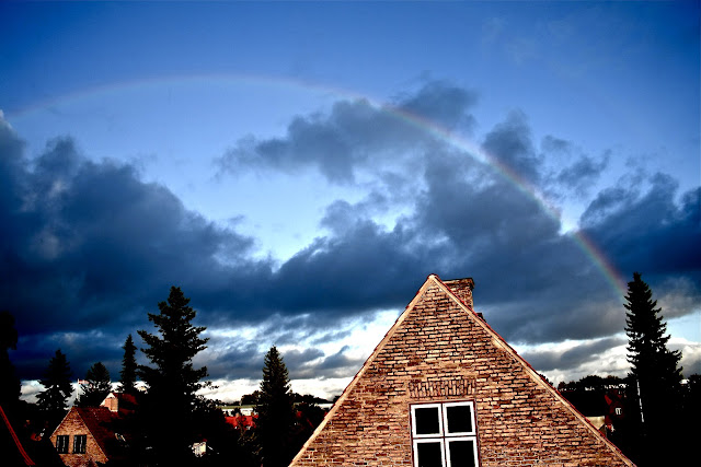 Rainbow on a beautiful blue sky over Copenhagen (København) taken from Hellerup. Rainbow at the same time as sunlight.