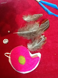 preparing to bezel bead the felted bird cabochon