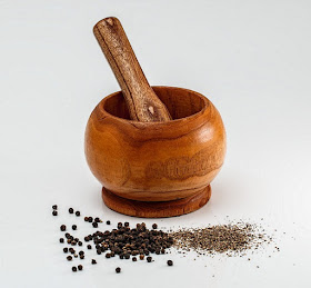 Cleaning a wooden mortar and pestle.