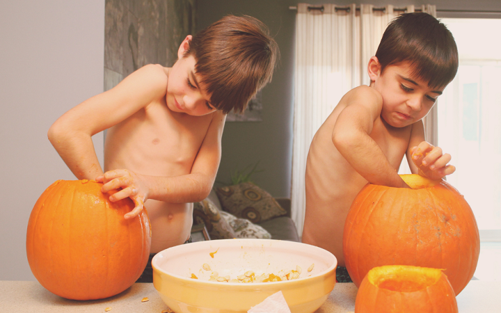 kids carving pumpkins for halloween