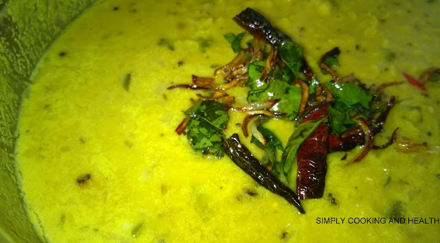 Tempered onion,dry chili and curry leaves added to dal curry