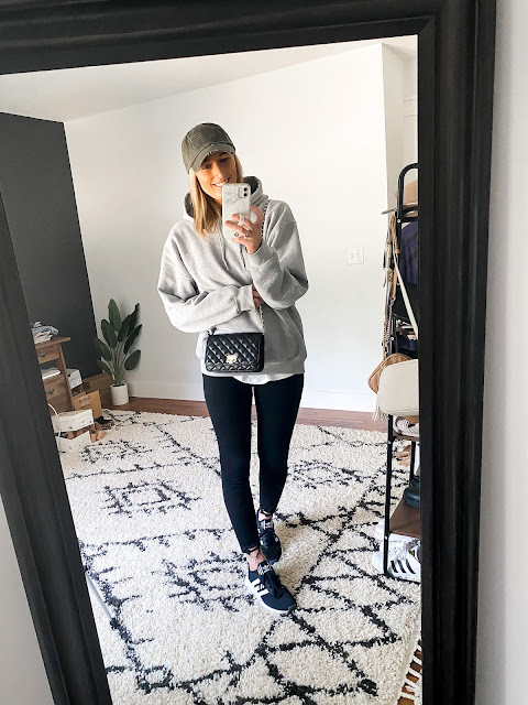 grey hoodie with black jeans womens adidas sneakers and baseball hat