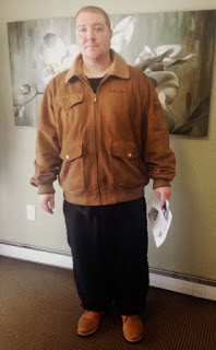 Photo of Joel in a brown coat in the Salem Green Apartments office