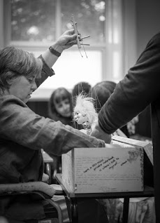 black and white photo of corina duyn lifting her puppet out of the box at the Puppet symposium