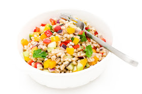 Cold pot barley salad peppers onion cucumber parsley in a bowl