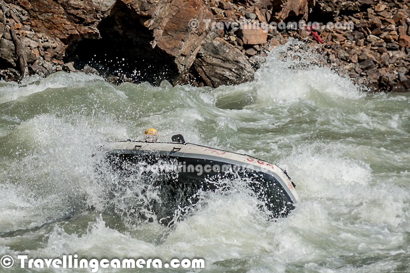 Rafting or white water rafting is one of the challenging recreational outdoor activity using an inflatable raft to navigate a river or other bodies of water having different levels of water-current. This is usually done on white water or different degrees of rough water, in order to thrill and excite the raft passengers. Rafting is considered an extreme sport, as it can be dangerous as times. This Photo Journey shares some of the photographs of Rafting in Risikesh, which is one of the popular places in India to do White Water Rafting.Recently we were in Rishikesh with office friends and Rafting was one of the top item in our list of things we wanted to do. We started in bus from Aspen Camps in Rishikesh and then boarded to jeeps with rafts. We had to start from Marine Drive which is a huge Ganges beach with enough space for folks to prepare and get started. Marine Drive is a place, strategically identified to start Rafting. Shivpuri is another preferred place to start Rafting. Idea is to make people comfortable with various types of water-rapids and then gradually start enjoying various stretches in river. Ganges provides a good range of water rapids and makes rafting an unmatchable experience.Rishieksh is one of the main places to do rafting in North India. Long time back I had done rafting in Vyas River near Kullu and that time all other rafters were professionals and I was covering a particular camp for Tourism Development program. Since I was not much involved in rafting activities, I couldn't enjoy it much that time. At Rishikesh, we had a wonderful coach/leader, who made rafting experience as great fun.After reaching Marine Drive Ganges beach, everyone of us got life jackets, a pedal and helmet. All three important things were with us and coach told us the best ways of using these three. All set with tight life-jacket, well settled helmet and appropriately gripped pedals we stepped into the raft after cleaning our feet in ganges water. It's recommended not to bring sand particles inside the raft, which can harm later. The coach threw chilling ganges water on us to start the journey in chilled water of ganges with different current levels. Coach with one of other Rafting professional entered into the raft. Then he briefed everyone of us about different commands like fast forward, move backward, stop etc. Initially it was difficult for us to gram every details of each command, but every command was very important for best rafting experience.Apart from basic Rafting commands, coach/leader also tells about basic rules of White Water Rafting. He also understands about each person sitting in the raft about their past experience with water. He also shares some basic steps for people who are not comfortable while sitting in raft. Of course, there are some standard rules to sit on a raft and make yourself comfortable even when body needs to stick with raft through feet in a particpular position. The Thumb rule is to listen your coach and follow him without any alternation, even in difficult situation. Idea is to trust the coach/Leader and follow his/her commands with any panic.So we started with baby steps and raft started moving towards Rishikesh (Lakshman Jhoola). For first 10 minutes, we were really slow and it was more of practice session, wehere coach was making us prepared for following his commands throughout the whole stretch we had to do in river. After practicing all the commands and moving our raft in circle, coach/leader asked us to stand on boundaries of raft and balance with pedal mounted on raft top. None of us could gather courage to stand on the boundaries and negotiated with coach/leader to stand inside the raft and try to balance with pedals. It was one of the major test for us and raft moves a lot. Many times, some of us stumbled and others were getting impacted because of imbalance. This task completed and coach/leader asked us to move forward.First we encountered Good Morning Rapid which is the beginning of Rafting experience. Good Morning rapid always come of the way and it doesn't matter that what was your starting point :). It was very basic but yet exciting because of first encounter with relatively fast flow of water-waves. Before hitting the rapid, some of the screaming while others were laughing to hide the fear :)All these photograph in this Photo Journey are clicked day before we did rafting. One day before we did rafting, we kept going to different places around river bed to shoot rafts sailing through high rapids of Ganges white water. Above photograph shows one of the raft getting up side down at Golf Course. One of the other leader jumped into the water to rescue raft and then every rafter. Within 5-8 minutes everyone was back on top of raft and moved forward towards Laxman Jhoola, which was end point. In such situations, ideally, everyone should listen carefully to what leader says and follow with panic. Things can get worse in case of avoidance of leader commands.The modern rafts are inflatable boats, consisting of very durable, multi-layered rubberized (hypalon) or vinyl fabrics (PVC) with several independent air chambers. The length varies between 3.5 meters and 6 meters, the width between 1.8 meters and 2.5 meters. The exception to this size rule is usually the packraft, which is designed as a portable single-person raft and may be as small as 1.5 metres long and weigh as little as 1.8 kilograms.Rafts come in a few different forms. In Europe and Australasia, the most common is the symmetrical raft steered with a paddle at the stern. Other types are the asymmetrical, rudder-controlled raft and the symmetrical raft with central helm (oars) or Stern Mounts with the oar frame located at the rear of the raft. Rafts are usually propelled with ordinary paddles and or oars and typically hold 4 to 12 persons. In Russia, rafts are often hand made and are often a catamaran style with two inflatable tubes attached to a frame. Pairs of paddlers navigate on these rafts. Catamaran style rafts have become popular in the western United States as well, but are typically rowed instead of paddled.Check out more at - http://en.wikipedia.org/wiki/RaftingAfter Good-Morning rapid, we crossed - Black Money, Three Blind Miles, Cross Fire, Shivpuri, Return to center, Roller Coaster, Tea off, Golf Course, Club House, Initiation, Body Surfing, maggie point & Cliff jumping, Double Trouble, Hilton and fianally Ram Jhoola. I went till Golf Course only and most of the other rafts from our group ended at Lakshman Jhoola.The most suitable time for River Rafting in Rishikesh is from September to November and from March to April-May. One of the best rivers in the world to experience the sheer exhilaration of white water rafting, it is the sheer invincible power of the Ganga river that often attracts the adventurer to the challenging sport of river rafting at Rishikesh.Generally White Water Rapids are divided into 6 levels of difficulty.Grade 1: Very small rough areas, might require slight maneuvering. (Skill Level required is very BasicGrade 2: Some rough water, maybe some rocks, might require some maneuvering. (Skill level: basic paddling skillGrade 3: Whitewater, small waves, maybe a small drop, but no considerable danger. May require significant maneuvering. (Skill level: experienced paddling skills)Grade 4: Whitewater, medium waves, maybe rocks, maybe a considerable drop, sharp maneuvers may be needed. (Skill level: whitewater experi\\Grade 5: Whitewater, large waves, large volume, possibility of large rocks and hazards, possibility of a large drop, requires precise maneuvering. (Skill level: advanced whitewater experience)Grade 6: Class 6 rapids are considered to be so dangerous that they are effectively unnavigable on a reliably safe basis. Rafters can expect to encounter substantial whitewater, huge waves, huge rocks and hazards, and/or substantial drops that will impart severe impacts beyond the structural capacities and impact ratings of almost all rafting equipment. Traversing a Class 6 rapid has a dramatically increased likelihood of ending in serious injury or death compared to lesser classes. (Skill level: successful completion of a Class 6 rapid without serious injury or death is widely considered to be a matter of great luck or extreme skill and is considered by some as a suicidal venture)In Rishikesh, we have crossed rapids of Level-3 difficulty as max. But it was great fun to face level three rapids. Water comes on to your body and pushes back and sometimes people get down into the water due to thrust.White water rafting can be a dangerous sport at times, especially if basic safety precautions are not observed. Both commercial and private trips have seen their share of injuries and fatalities, though private travel has typically been associated with greater risk. Depending on the area, safety regulations covering raft operators may exist in legislation. These range from certification of outfitters, rafts, and raft leaders, to more stringent regulations about equipment and procedures. It is generally advisable to discuss safety measures with a rafting operator before signing on for a trip. The equipment used and the qualifications of the company and raft guides are essential information to be considered.Like most outdoor sports, rafting in general has become safer over the years. Expertise in the sport has increased, and equipment has become more specialized and increased in quality. As a result the difficulty rating of most river runs has changed.