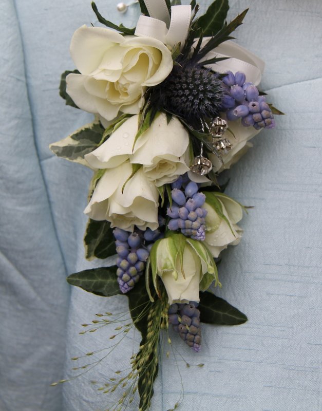 Mum's Corsage to tone with ice blue included Muscari Roses and blue 