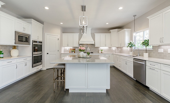 Enjoy a spacious kitchen, center island, and upgraded appliances in this St. Louis County home by Genesis Development.