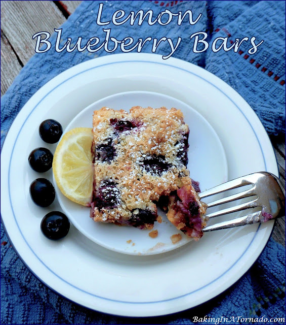 Lemon Blueberry Bars take the classic lemon bar recipe to a whole new level. |recipe developed by www.BakingInATornado.com | #recipe #dessert