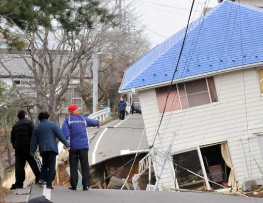 japan earthquake 2011 damage. Residents check the damage to