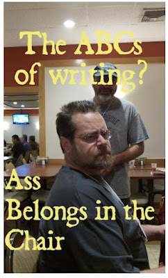 author James A. Moore sitting in a chair looking sternly at the camera sideways and the words in yellow overlaying the image: The ABS's of Writing? Ass Belongs in the Chair