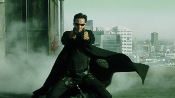 Keanu Reeves firing two pistols in The Matrix