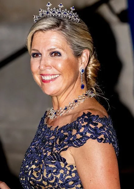 Queen Maxima wore a navy lace top and maxi skirt by Claes Iversen. Sapphire tiara, sapphire necklace and sapphire diamond earrings