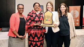 Minister mhagama with various partners from US