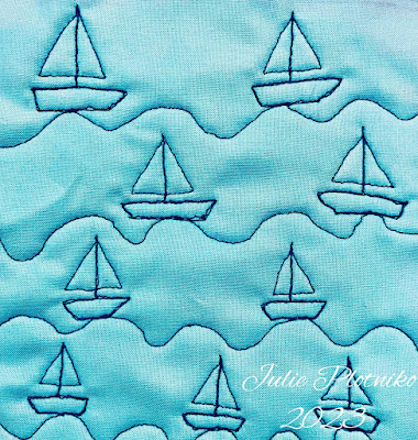 Blue stitching of sail boats on a blue background