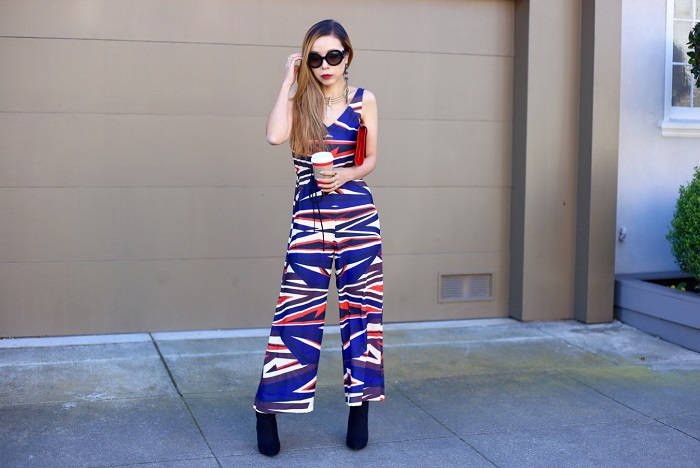 clover canyon dynamic sunset jumpsuit, saint laurent clutch, pointy toe ankle booties, starbucks holiday red cup, baublebar statement choker necklace, baublebar drop earrings, prada sunglasses, fashion blog, street style, holiday outfit, holiday jumpsuit, holiday outfit ideas