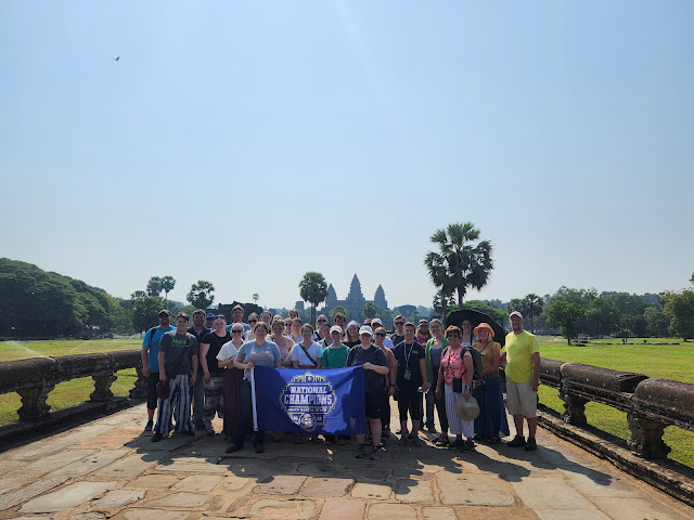 Travel group with Go Jacks banner