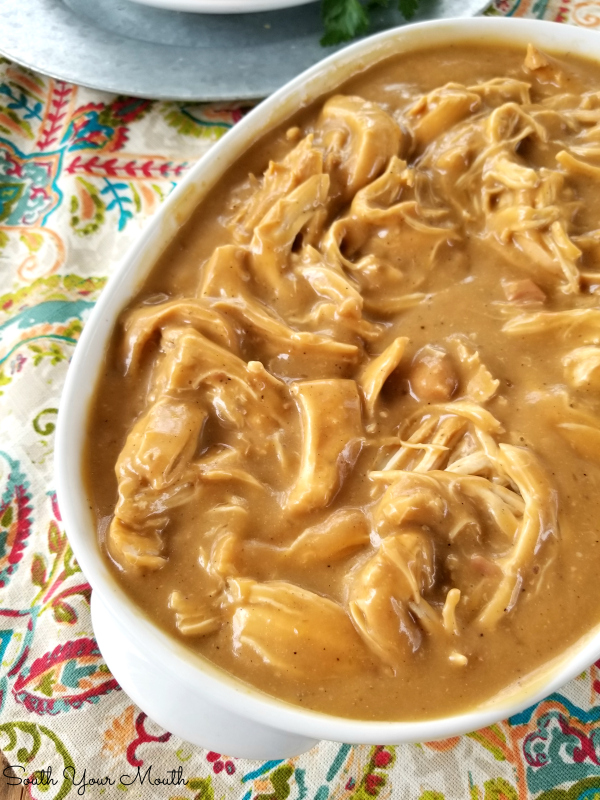 The BEST Crock Pot Chicken & Gravy! An easy slow cooker recipe for tender chicken breasts and savory gravy perfect served over mashed potatoes, noodles or rice.