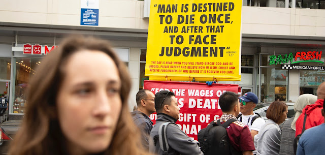 street preacher holding sign about judgment