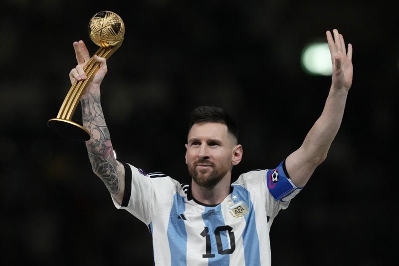rgentina s Lionel Messi waves after receiving the Golden Ball award for best player