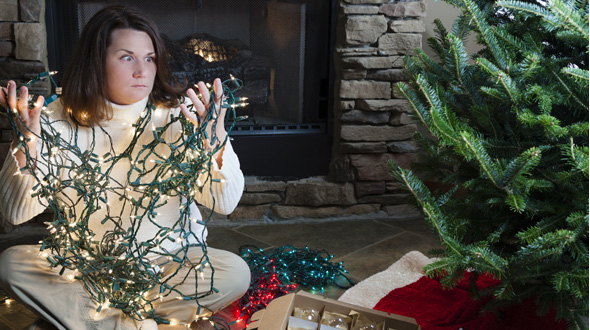 Preparing to hang lights on a fresh cut Christmas tree