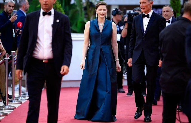 Princess Charlene wore a sleeveless navy gown by Akris. Federica Tosi gown. Diamond necklace and earrings
