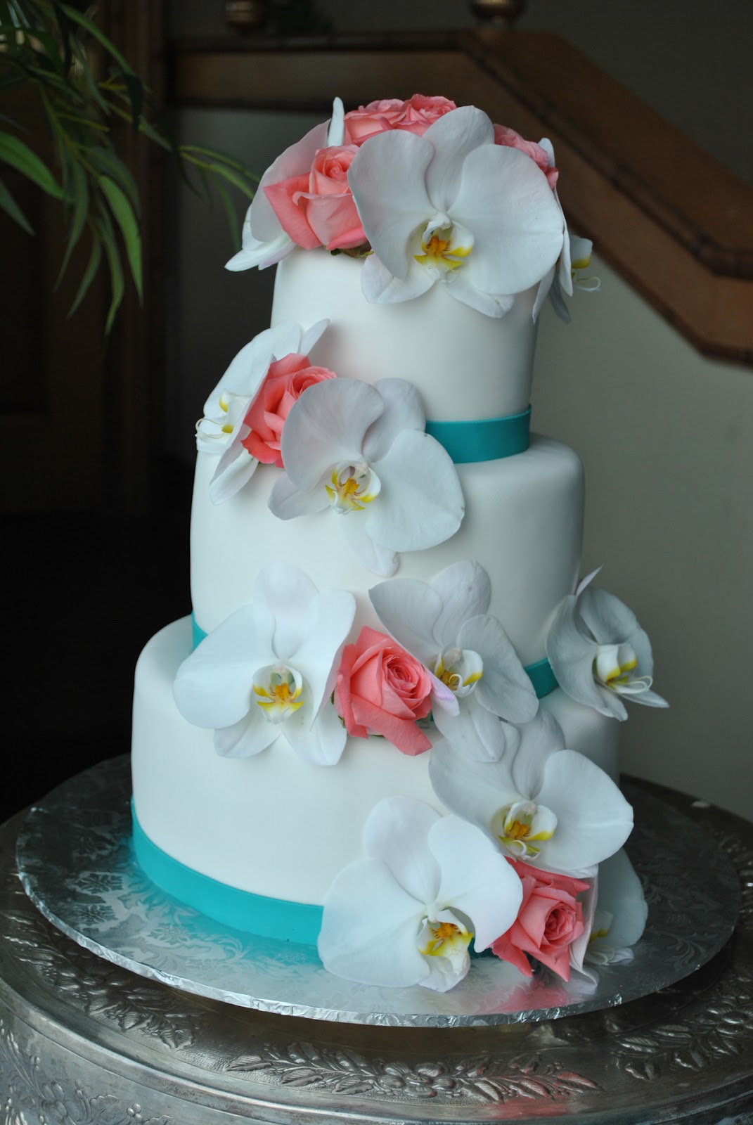 traditional wedding cake topper White orchids and coral roses wedding cake by The cake Zone