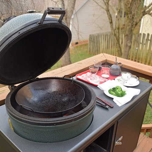 Large Big Green Egg kamado grill in a Challenger Designs Torch grill cart.