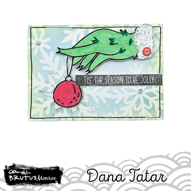 How to transform a hand stamp into the Grinch by coloring and cutting the stamped image out and placing it onto a stenciled artist trading card base.