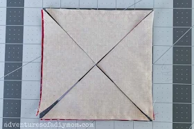 image depicting cuts through fabric diagonally from corner to corner in both directions