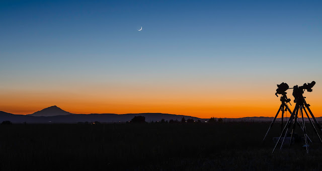 Mt. Shasta, a crescent Moon and telescope mounts in sunset glow