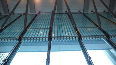 Image of something in the ceiling of the main foyer of the flagship HSBC branch in Hong Kong, as seen from inside the building. It's a stainless steel portcullis!