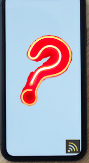 A phone screen with a question mark and TheTechBoy logo on it.