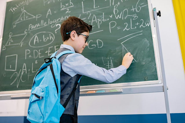 schoolboy-solving-math-examples-on-whiteboard-in-classroom