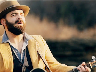 Drew Holcomb playing the guitar