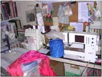 crowded sewing table with boxes underneath