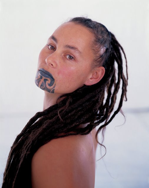 Crowning her lips and chin with all its glory is a moko tattoo.