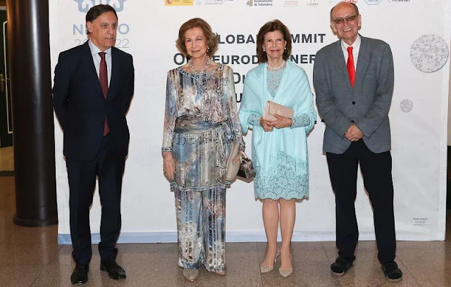 Queen Sofia and Queen Silvia attended a concert in Salamanca. Silvia wore a lace dress, Sofia wore a floral print silk jumpsuit