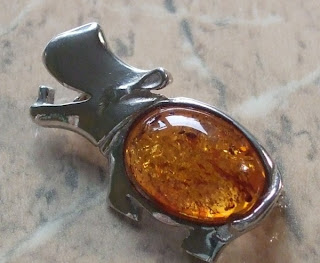 Amber rhinoceros brooch in silver