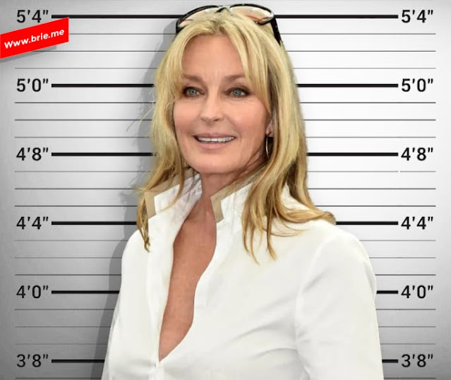 Bo Derek standing in front of a height chart
