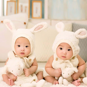 twins-babies-sitting-with-wearing-rabbit-type-clothes