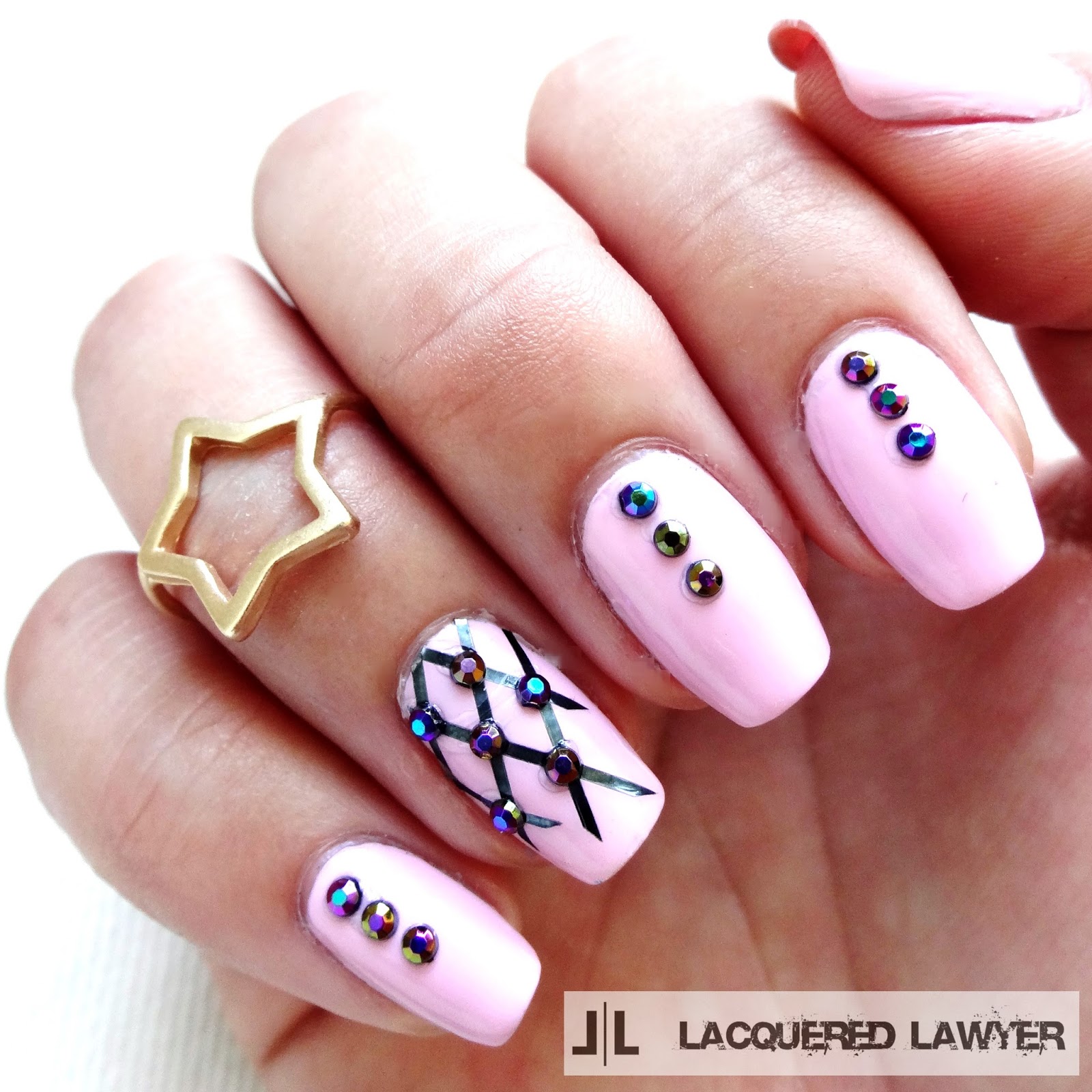 Pink nail art with iridescent studs