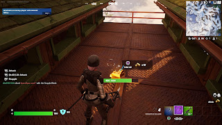 Arctica collects gold bars from a defeated player's remains in Fortnite.