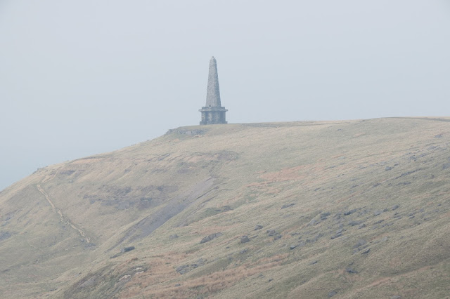 On the edge of Higher Moor, Stoodley Pike monument - a squat stone base surmounted by a obelisk-like structure.